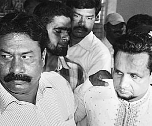 Bendigeri police taking Aslam Baba to the police station in Hubli on Sunday | Express Photo