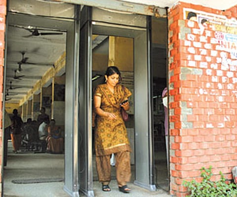 A commuter passing through the metal detector installed at the centre.