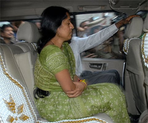 Senior IAS officer Y Sri Lakshmi siting inside the car along with her husband after her bail was granted on condition in Hyderabad on Friday. EPS