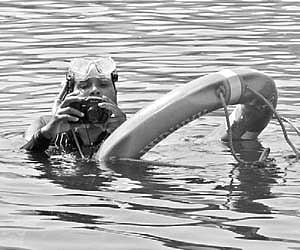 An underwater technical expert, engaged in photographing the structure of the Mullaperiyar dam, gets ready to dive with a camera.