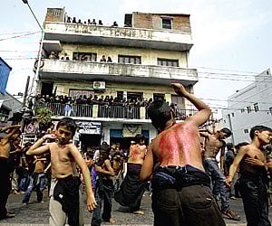 Bare-chested children and men beat their chests and backs during Muharram in the city | P Ravi Kumar