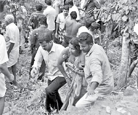 A woman who was pulled out from the river being led to the ambulance.