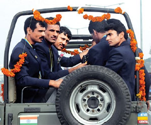 The Guangzhou Asian Games Indian medal winners Saji Thomas, Bajrang Lal Takhar, coach Ismail Baig and Giriraj riding back to Boat Club in City. EPS