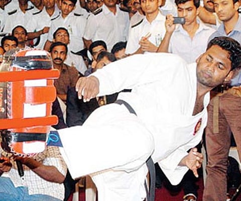 Midhun Jith attempting for a Guinness World Record in martial arts kicks at the Town Hall in Kochi on Friday.