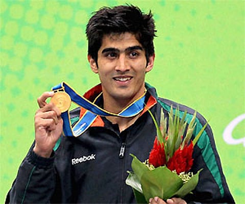 Vijender Singh shows his gold medal that he won in the men's 75kg category. PTI Photo