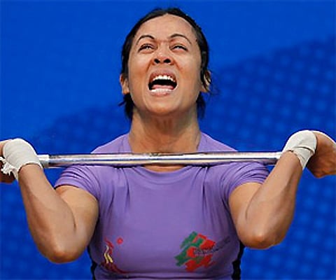 Molla Shabira of Bangladesh reacts after attempting a lift in the women's 48 kg weightlifting event. AP Photo