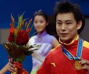 China's Xiaochao Yuan holds his medal up after winning the gold medal in the men's Changquan section of the Wushu event at the 16th Asian Games (AP)