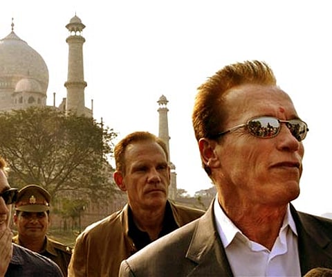 Arnold Schwarzenegger, right, stands in front of the historic Taj Mahal, in Agra (AP Photo/Pawan Sharma).