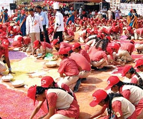 Students of Cavin Kare School working on a world map for the LIMCA record in mass vegetable carving | Express