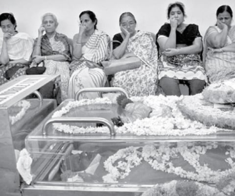 The relatives of Venu Nagavally sitting beside his body when it was kept at the VJT Hall for the public to pay homage on Thursday. Venu’s wife Meera (