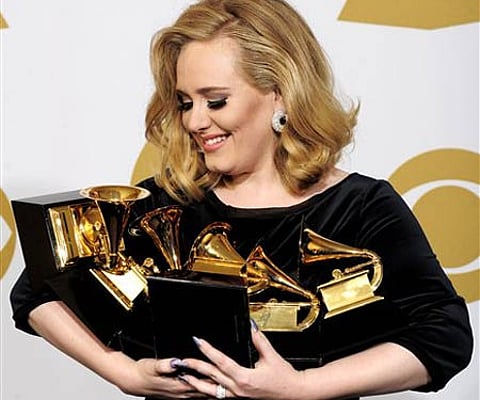Adele poses backstage with her six awards at the 54th annual Grammy Awards (AP Photo/Mark J. Terrill).