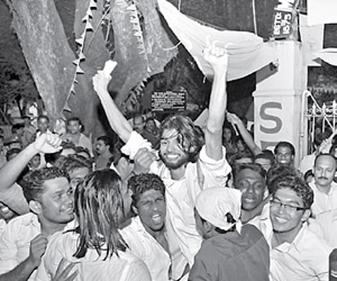 Students of Maharaja's College lift Jino John who won the chairman's post on the KSU ticket.