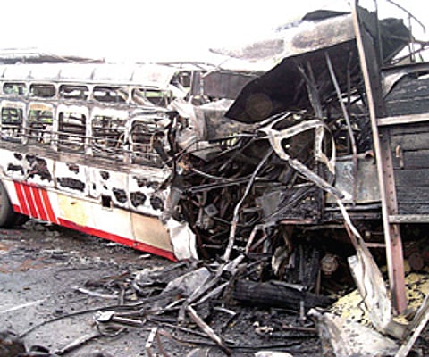 The burnt lorry and government bus at Mallavadi village on Wednesday.