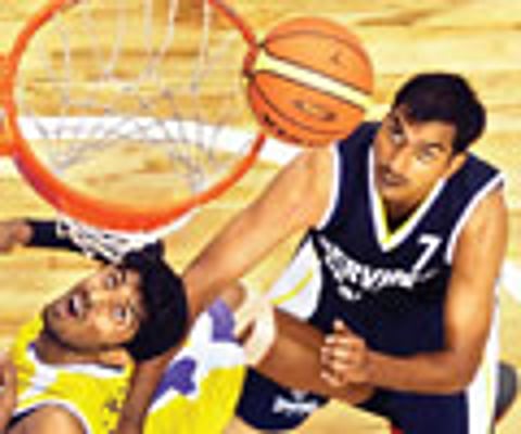 Tamil Nadu & Services players in action during their semifinal clash in the National Basketball Championship in Chennai on Friday