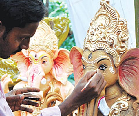 An artisan giving finishing touches to an idol of Lord Ganesh in Bhubaneswar on Sunday | EXPRESS PHOTO