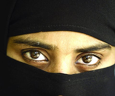 A burqa clad woman. EPS