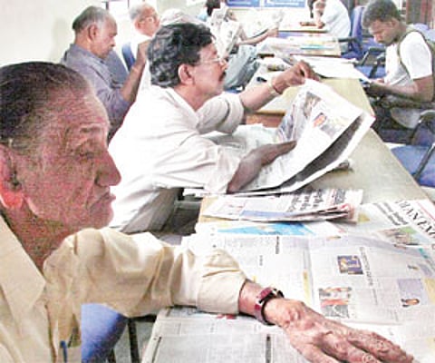 Readers going through newspapers in BTM Layout library | jithendra m