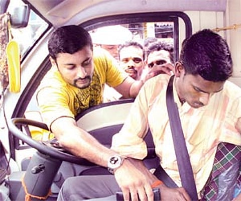A man being helped with his seat belt| Express photo