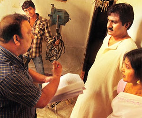 Director Mahesh with his actors during the shoot; (below) A still from the film
