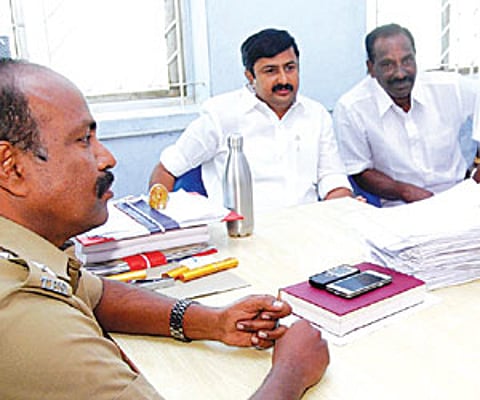game’s up: Ex-minister for highways M P Saminathan (second from L) at the Tirupur SP office on Monday.