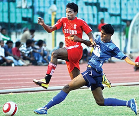 Players of Chennai Customs and Chennai FC battle for the ball in the Senior Division League on Thursday