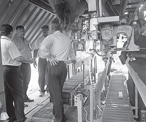Cochin Port Trust Chairman Paul Antony along with other senior officials inspecting the automatic fertiliser bagging unit