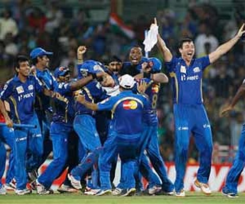 Mumbai Indians celebrate their win over Royal Challengers Bangalore in the CLT20 cricket final match in Chennai. AP