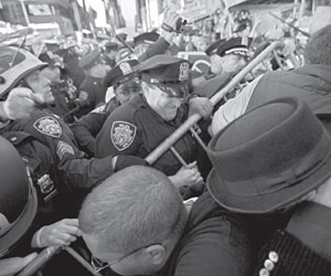 PEOPLE POWER: Occupy Wall Street participants try to push through a police barricade to take their demonstration onto the street in Times Square.