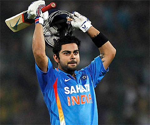 Virat Kohli gestures after scoring a century during the second one-day international cricket match against England in New Delhi, Monday. (PTI)