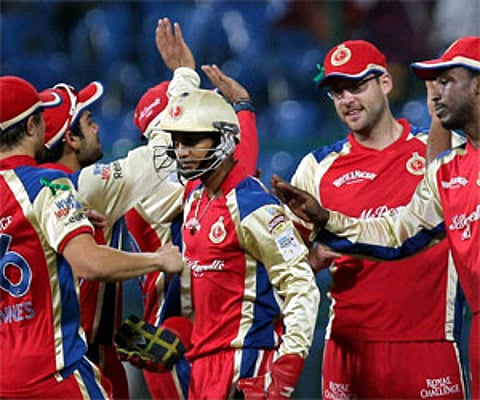 Royal Challengers Bangalore Syed Mohammad with team mates celebrate the wicket of Michael Klinger of South Australian Redbacks. (PTI)