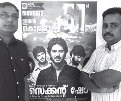 Vivek Ramadevan, the CEO - Content & Marketing, and Prasanth Narayanan, MD of AOPL Pvt. Ltd., next to a 51st day poster of ‘Second Show | EPS