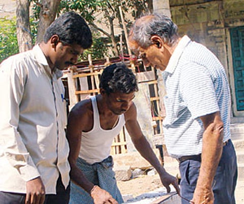 Dr T Satyamurthy inspecting stone engravings during one of his visits to a heritage site.