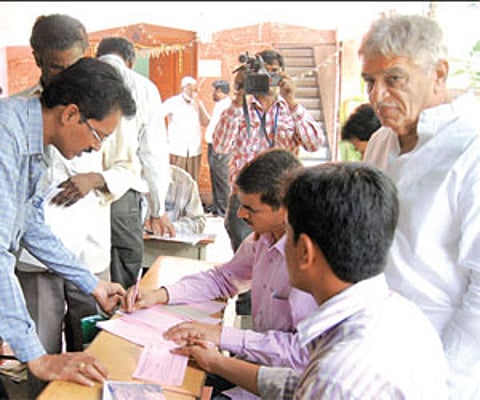 Chukka Ramaiah (right) monitors the issuance of application forms at his institute in Hyderabad on Friday.