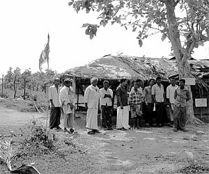 Tribesmen from communities like Urali Kurumbar, Kattu Naikar, Paniyar and Kurumar near a hut erected for the strike at Appad in Wayanad|Express.