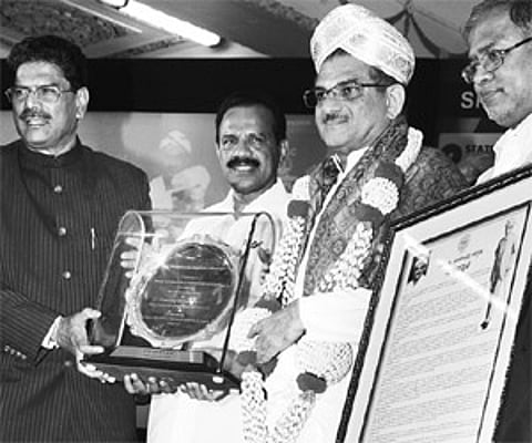 Chief Minister D V Sadananda Gowda felicitating Dharmasthala Dharmadhikari Dr Veerendra Heggade with Sir M Visvesvaraya Memorial Award.