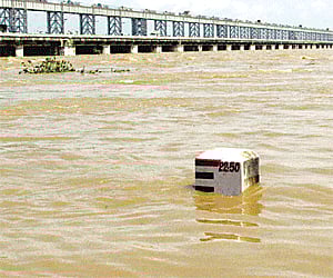 A view of the swollen Mahanadi river flowing above the danger mark near Mundali in Cuttack on Saturday. I PTI