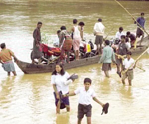 People ferry vehicles in a boat in Dasarathpur block in Jajpur district on Tuesday I Express
