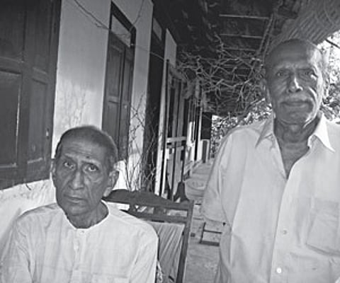 Peter Thomas (sitting) and V T Thomas (Toms) at their ancestral home in Veliyanad | ENS