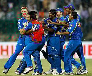 Mumbai Indians players and support staff celebrate their win over Trinidad and Tobago in Bangalore on Monday, Sept. 26, 2011. (AP)