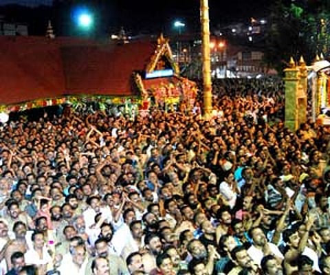 Pilgrims witnessing Makarajyothi from the Sopanam of the Lord Ayyappa temple - Express file Photo