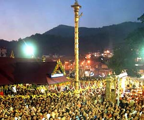 Pilgrims witnessing Makarajyothi from the Sopanam of the Lord Ayyappa temple - Express file Photo
