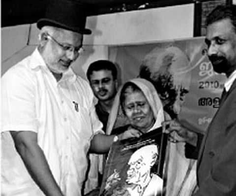 express Education Minister M A Baby receiving a caricature of Vaikom Muhammad Basheer at a function held at Alakapuri hotel on Sunday. Basheer’s wife