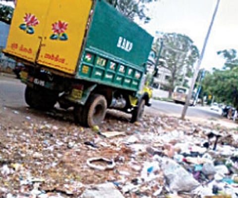 The BBMP van passes by the garbage pile without clearing the litter | express photo