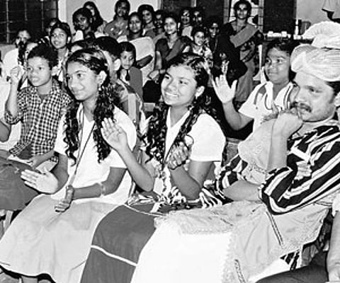 Kozhimala King Arayan Raj Mannan and tribal children attending English class at the village school in Kozhimala