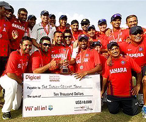 Indian cricket team pose with their trophy after winning their three match series against the West Indies 1-0 in Dominica, Sunday. AP