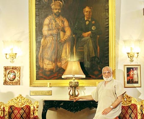 The Prince of Arcot poses by a portrait of an ancestor; ceremonial guards at one of the palace’s entrances.