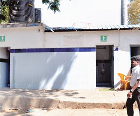 (Top) Poorly maintained Nirmala toilets. (Above) A poster that depicts the irony of the situation