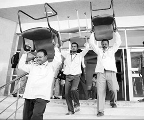 GHMC officials attaching the furniture from the APSRTC Kalyana Mandapam for defaulting on payment of taxes in Hyderabad on Wednesday.