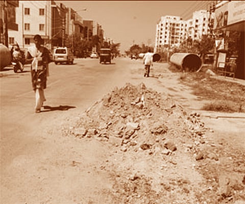(Left) Sector 1, Main Road in HSR Layout dug up to lay the Cauvery water pipes; (Right) An open drain in the ward