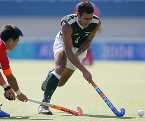Pakistan hockey player Rehan Butt in action in the men's field hockey preliminaries against Korea. (Getty Images)